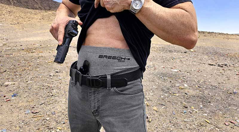 Drawing a Walther PDP pistol  from concealment while wearing Breech Gear's mid-waisted conceal carry underwear.